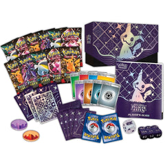 Pokémon trading card game set with cards, guidebook, and dice on a white background